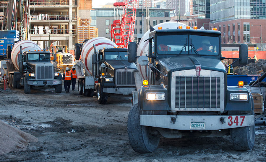 Cement trucks in line on construction site