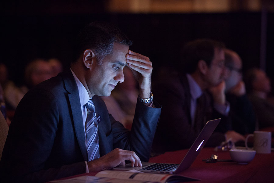 engaged attendee looking at computer