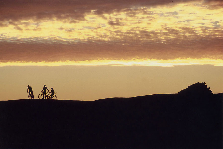 Mountain bikers at sunset, Moab, Utah